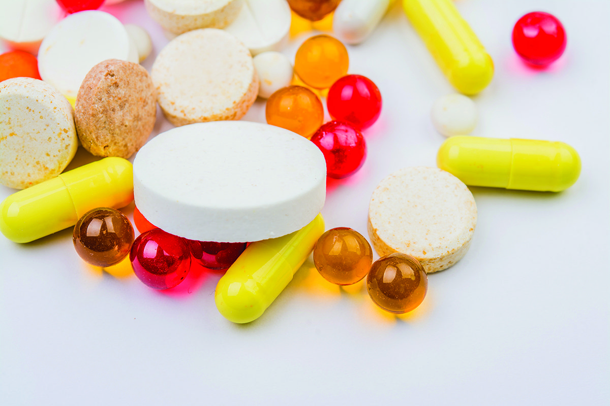 Assorted pharmaceutical pills spilled on a white surface