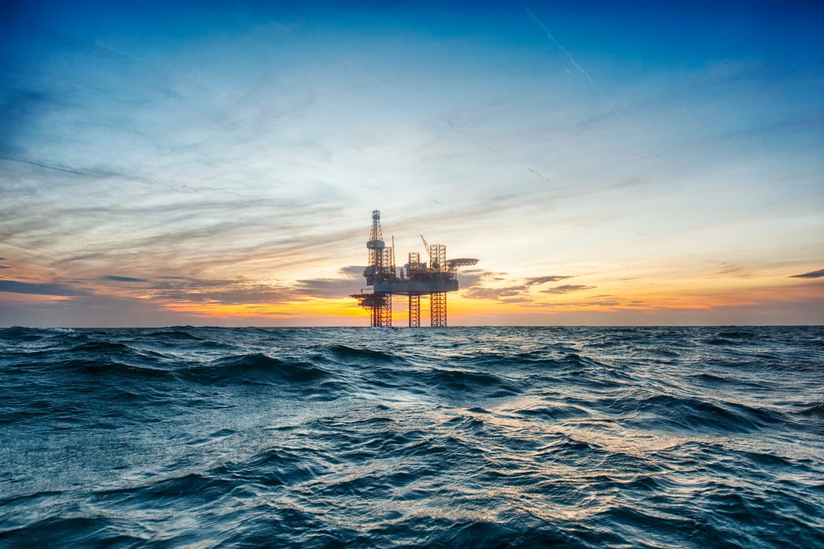 Oil platform in sea landscape at dawn