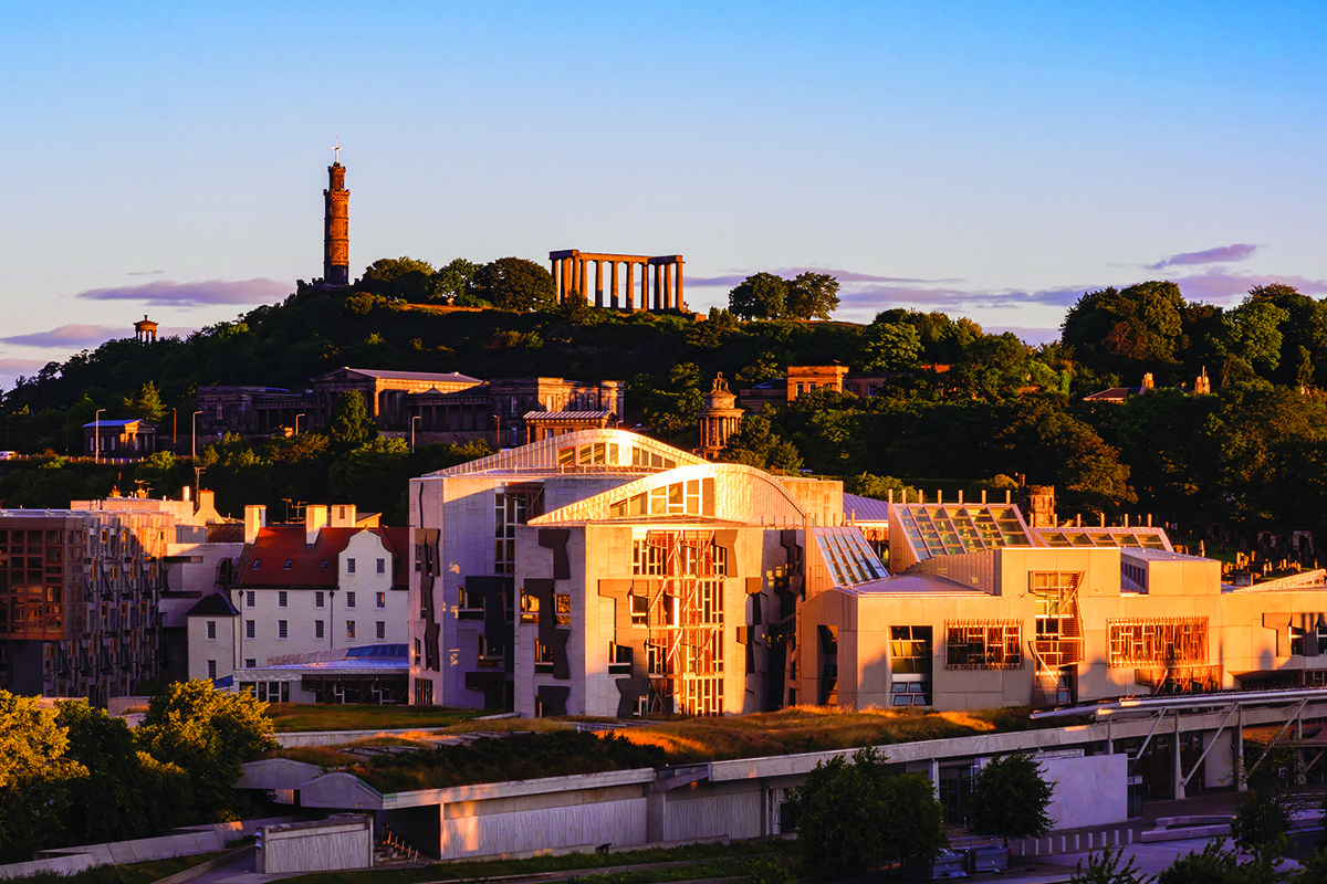 The Scottish Parliament in orange-fringed twilight of dawn