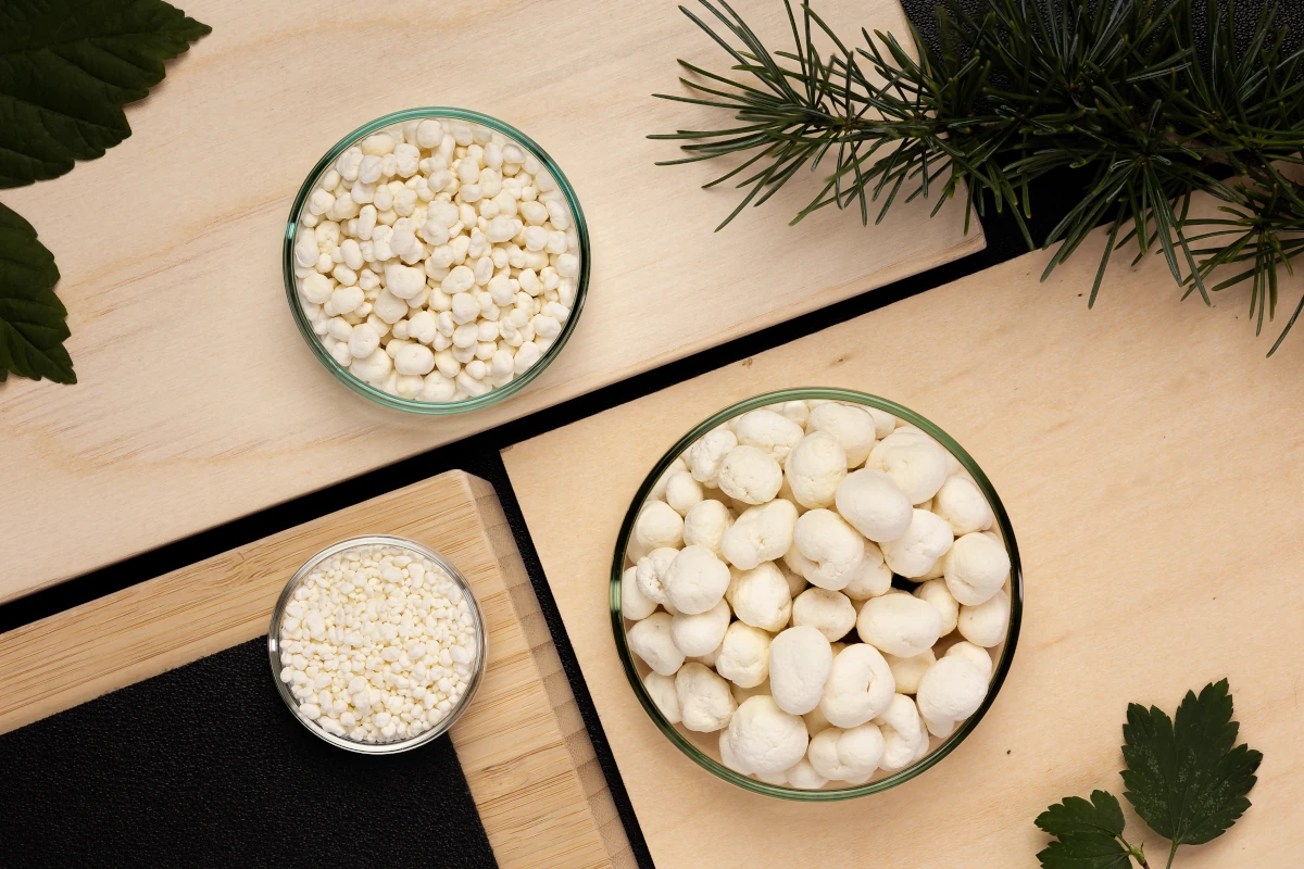 Beige balls of material arrayed in open containers in an art studio
