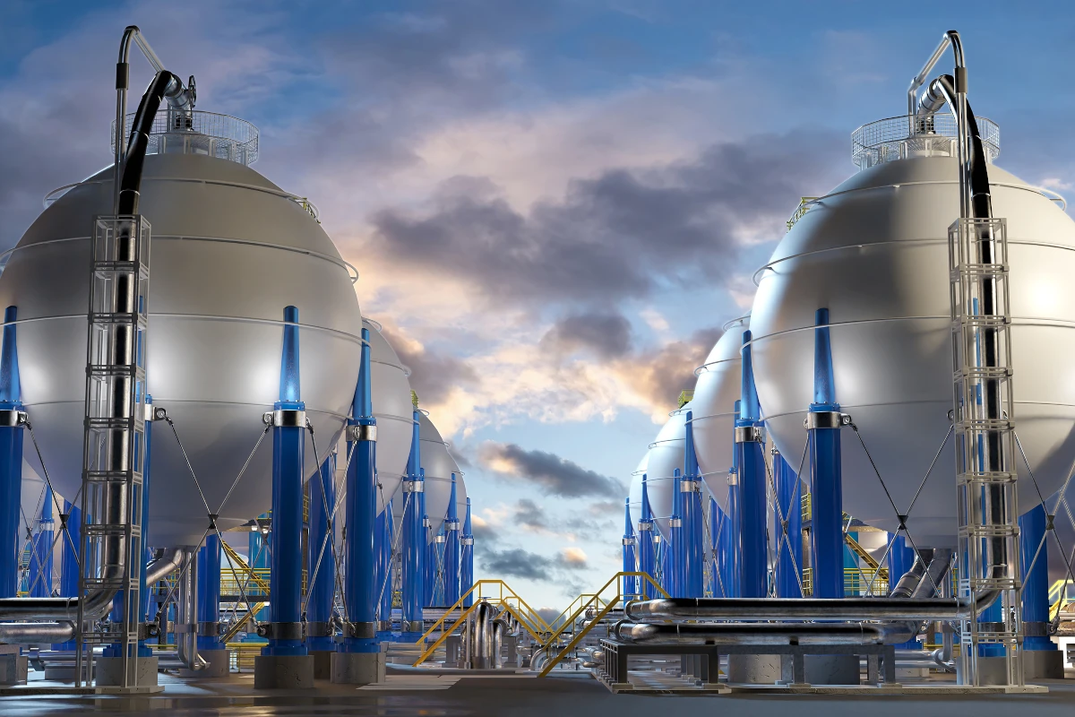 spherical fuel tanks extending towards the horizon, against a violet-hued cloudy sky