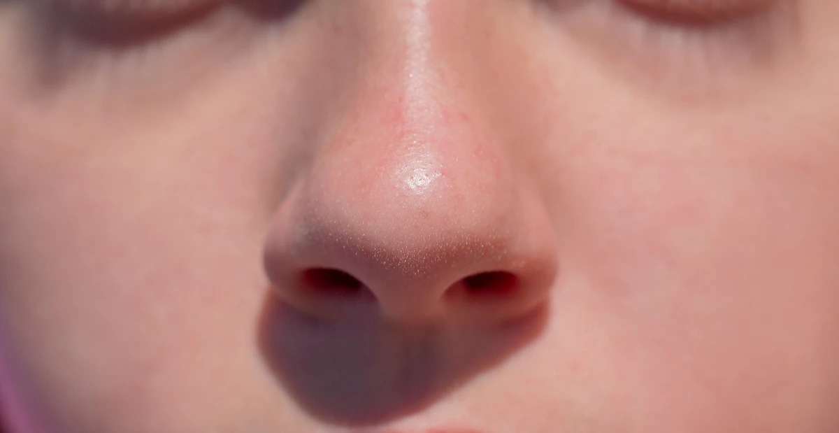 Close-up of human face with only nose and cheeks visible
