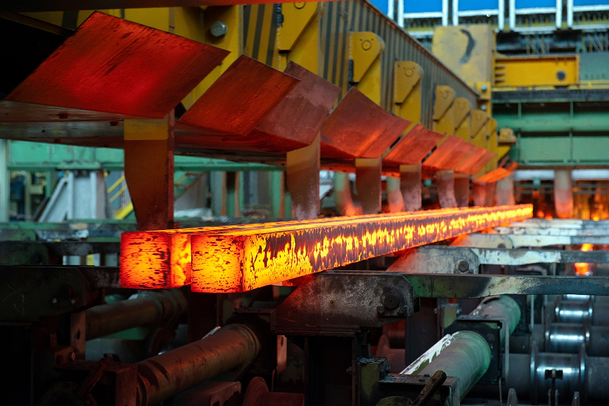 Long rods of red hot steel during steel production
