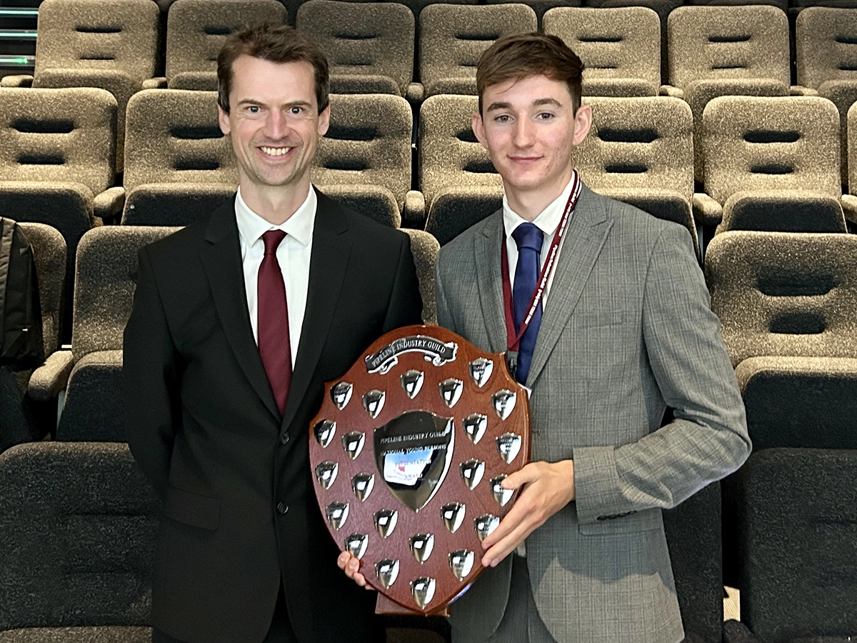Scottish Water employee Zac Mooney holding an award shield